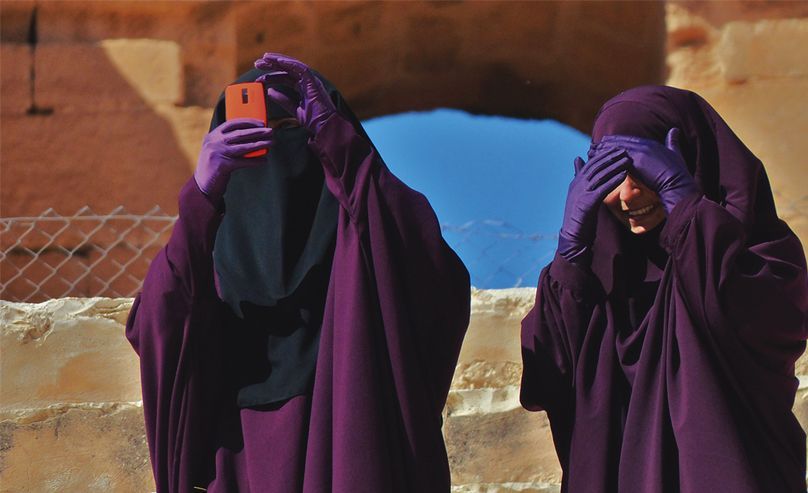 Women taking pictures with smartphones