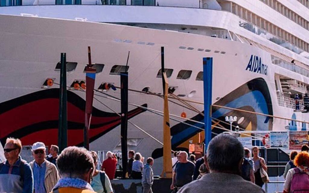 Cruise ships docked at a historic city port, highlighting the impact of tourism on urban and natural environments