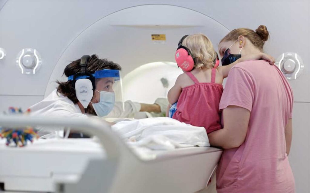 Nick Turk-Browne prepares infant participant for memory encoding MRI study at Yale