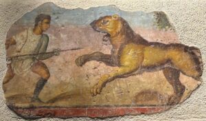 Pintura mural romana de un venator frente a un león